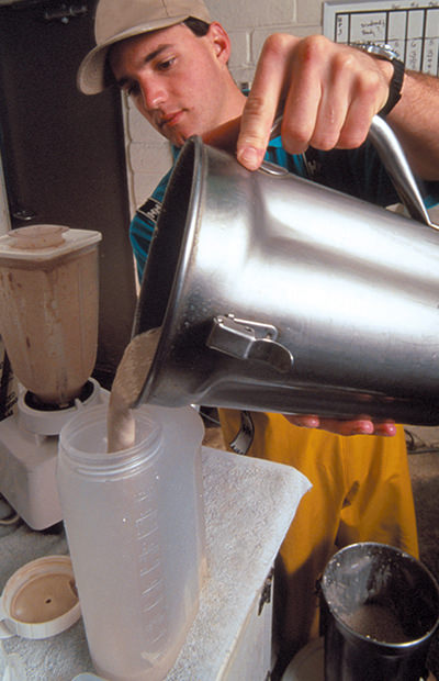 A rescue staff member prepares a food bottle