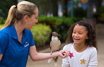 Girl making connection with a bird at SeaWorld.