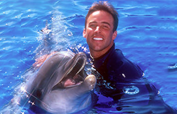 Sea World animal trainer with bottlenose dolphin